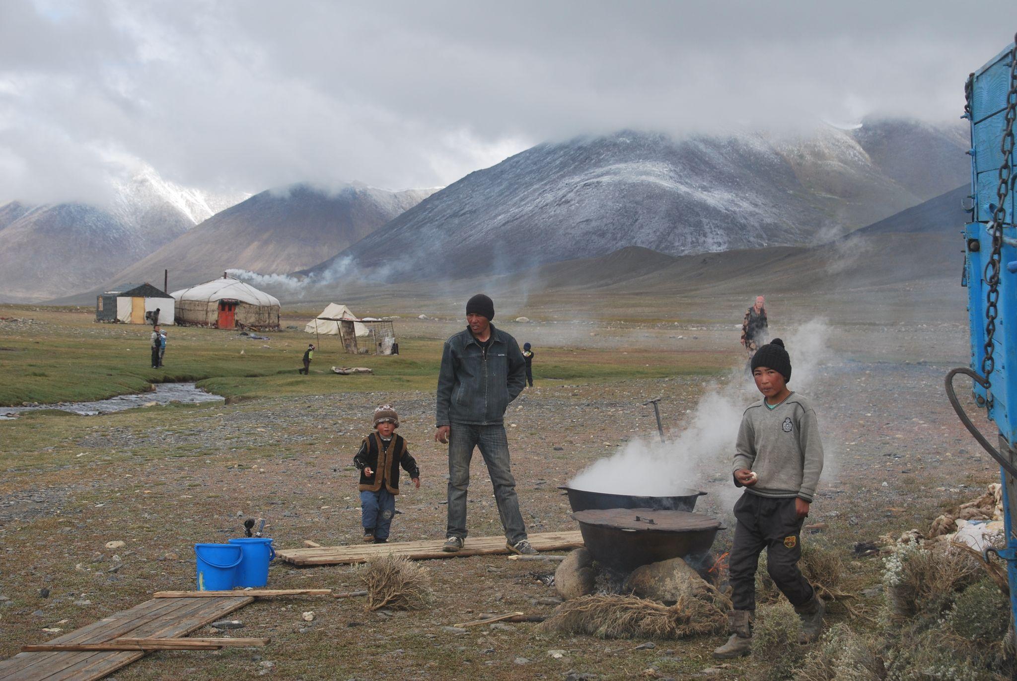Yurt with mountains, people cooking